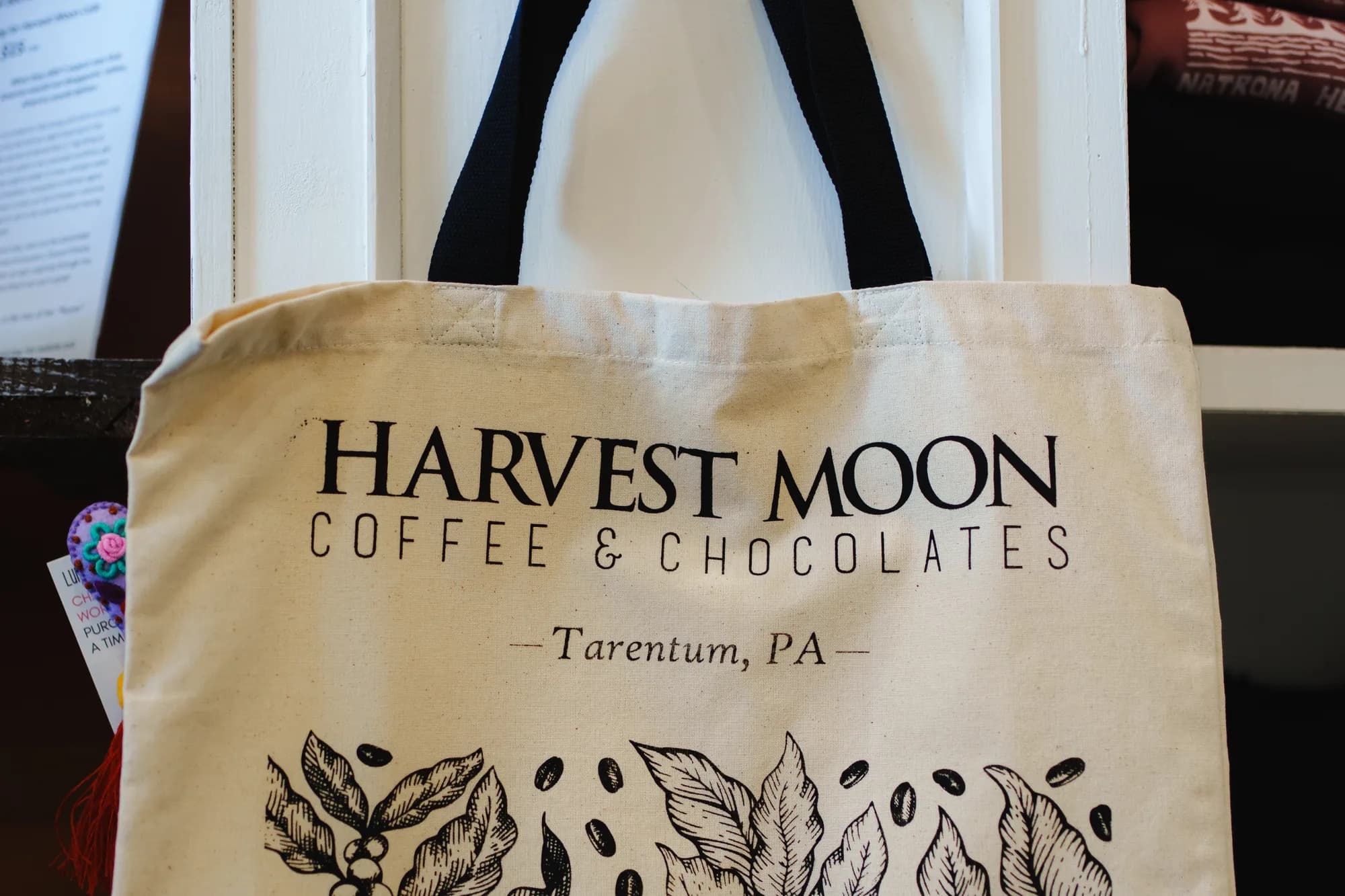 Harvest Moon canvas tote bags hanging in the shop